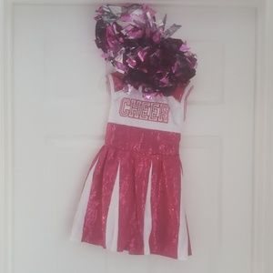 Cheerleading costume with pom poms